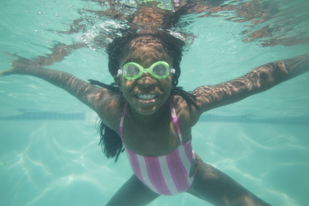 child swimming under the water