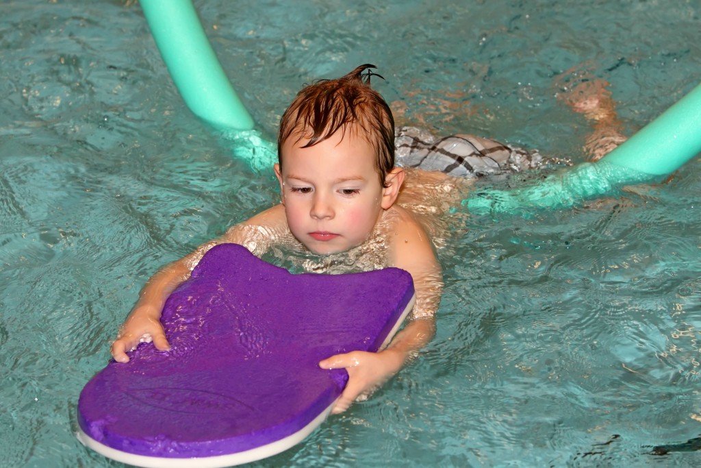 child swimming with float-web